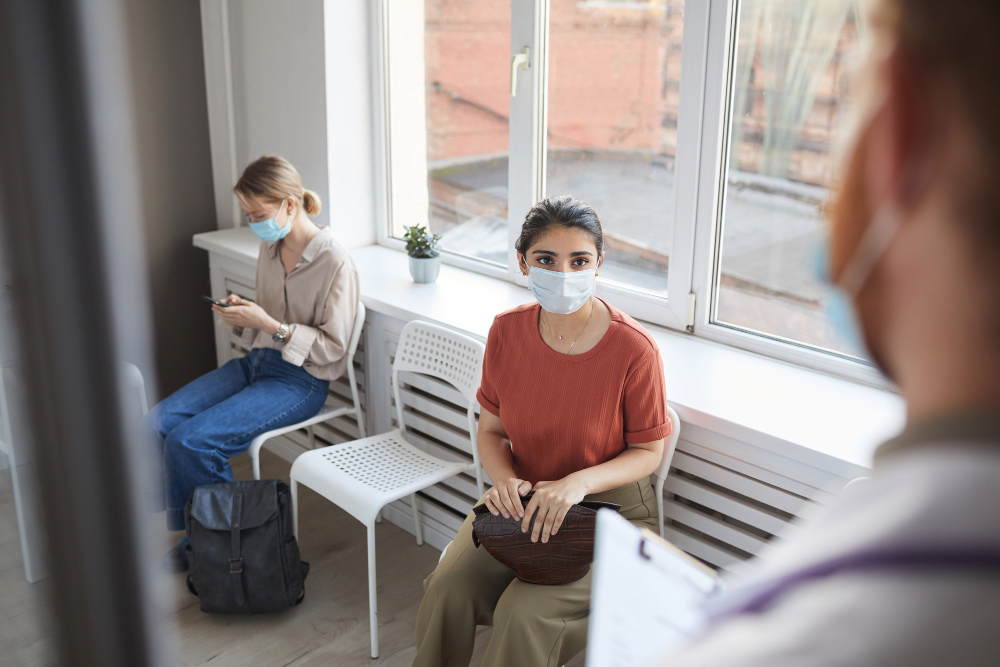 young-woman-protective-mask-sitting-queue-hospital-while-doctor-meeting-her-2